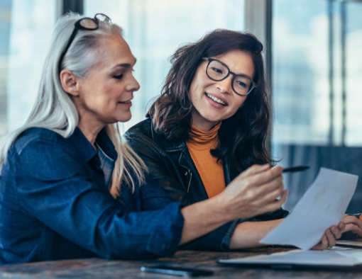 Two med spa professionals reviewing end-of-day paperwork together